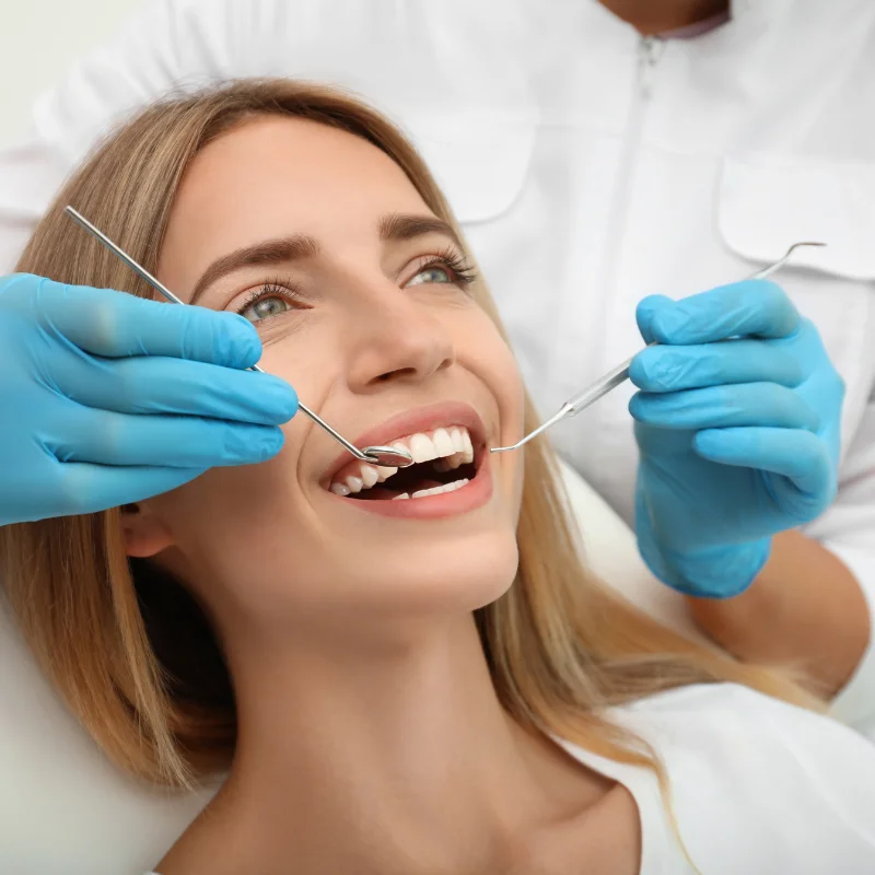 Female patient smiling during dental exam at cosmetic dentistry consultation
