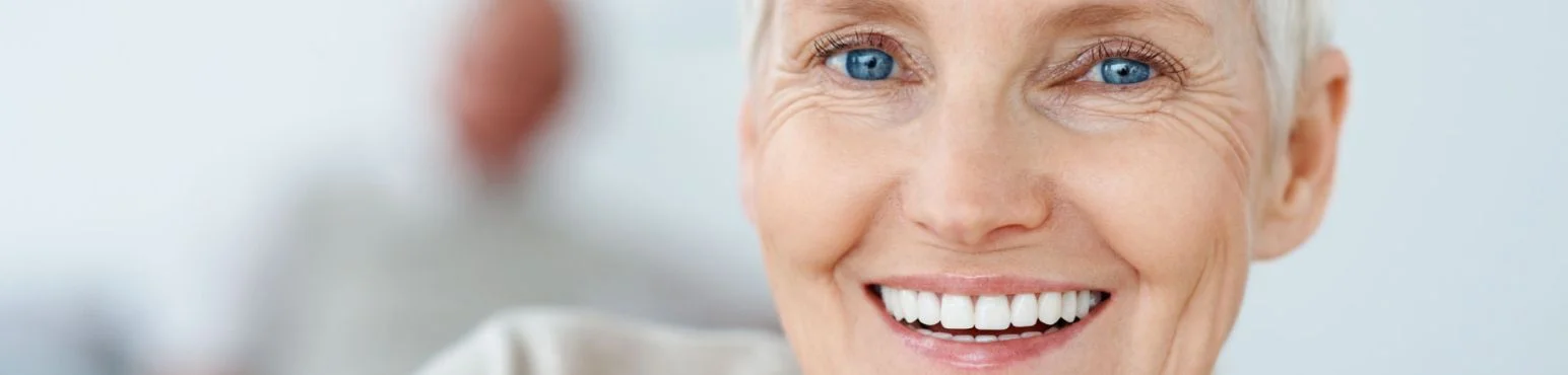 Full dentures for restoring missing teeth at Parkside Drive Dental Waterloo ON Senior female patient smiling with full dentures, showing natural-looking tooth replacement at Parkside Drive Dental in Waterloo, ON